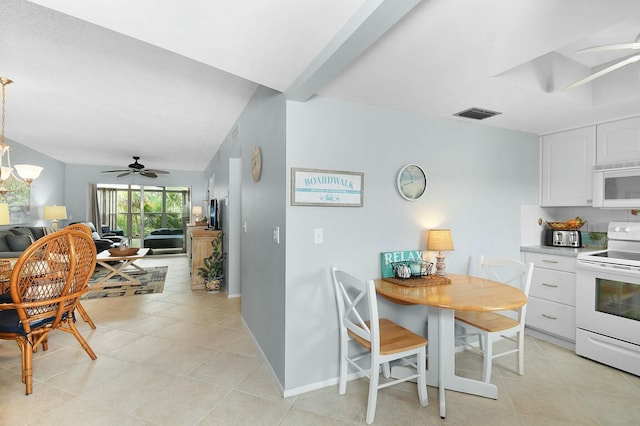 kitchen with light tile patterned flooring, visible vents, white cabinets, and white appliances