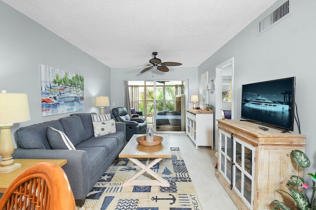 living area with ceiling fan, visible vents, a textured ceiling, and light tile patterned flooring