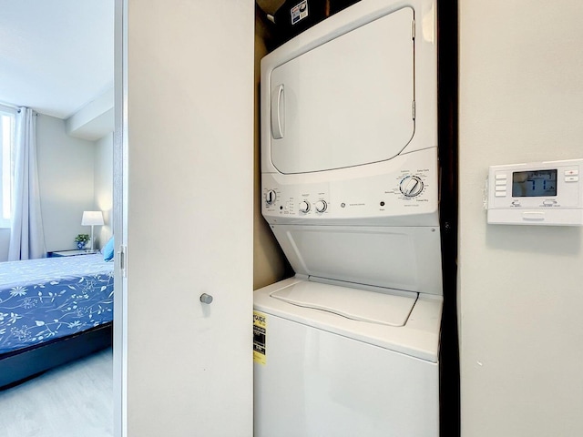 washroom with laundry area and stacked washer / dryer