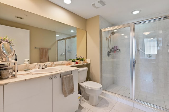 full bathroom featuring tile patterned floors, vanity, toilet, and a shower stall