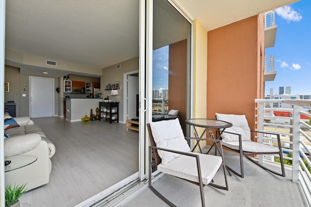 balcony featuring visible vents and a view of city