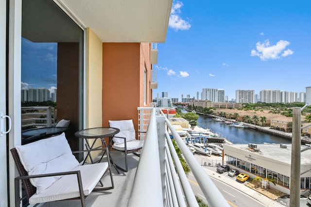 balcony featuring a view of city and a water view