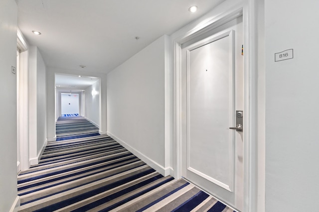 hallway with recessed lighting, carpet, and baseboards