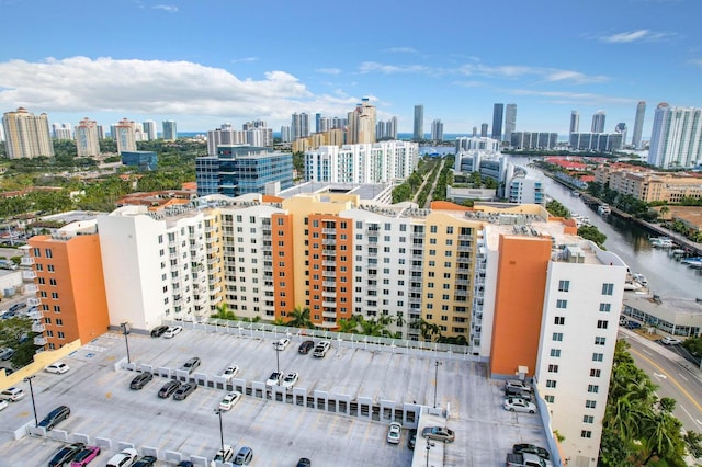 drone / aerial view featuring a view of city and a water view