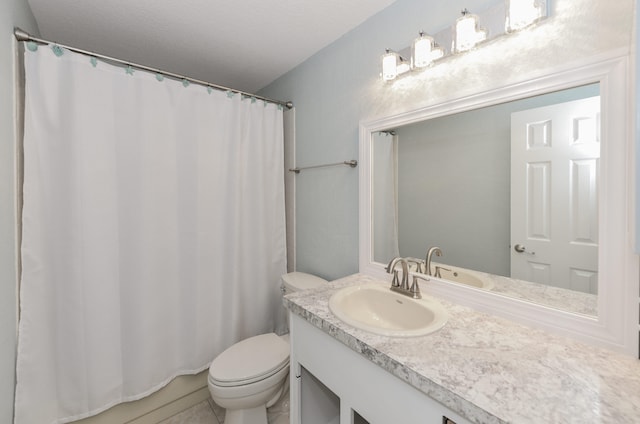 bathroom featuring curtained shower, toilet, and vanity