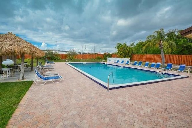 community pool featuring a patio area and fence