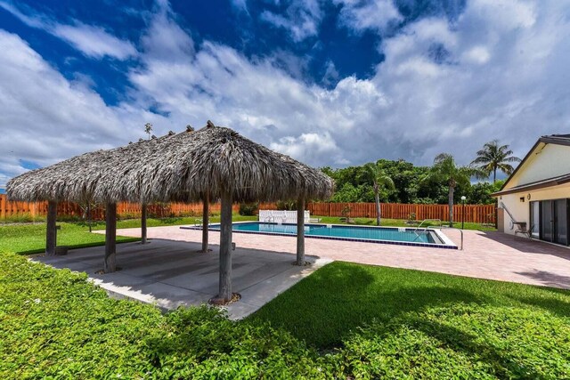 view of pool featuring a patio, a lawn, a fenced in pool, and a fenced backyard