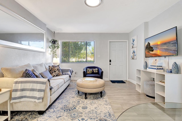 living room with baseboards and wood tiled floor