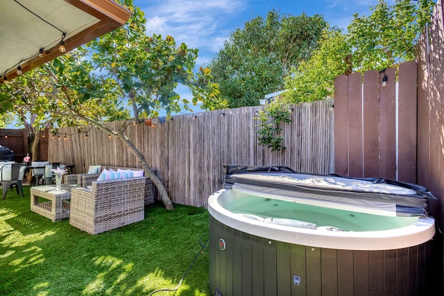 view of yard featuring fence and a hot tub