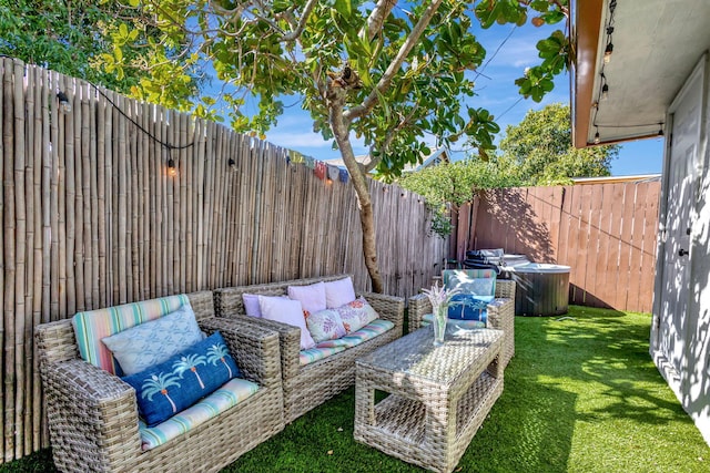 view of patio / terrace featuring outdoor lounge area, a fenced backyard, and a hot tub