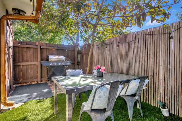 view of patio / terrace featuring outdoor dining space, fence private yard, and area for grilling