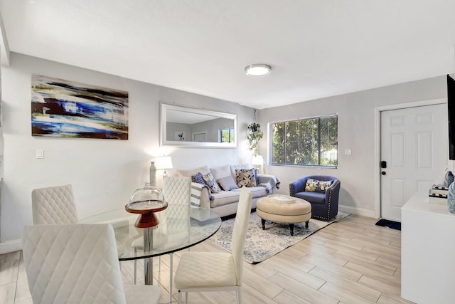 living room featuring light wood-type flooring and baseboards