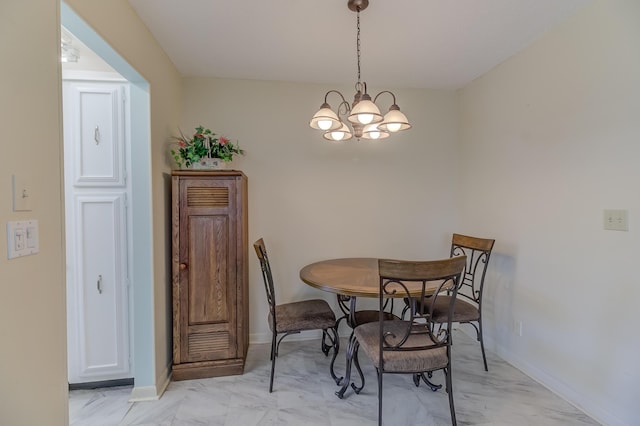 dining room featuring baseboards, a notable chandelier, and marble finish floor