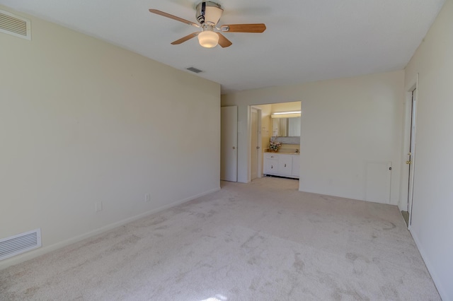 unfurnished bedroom with visible vents, light carpet, and ensuite bathroom