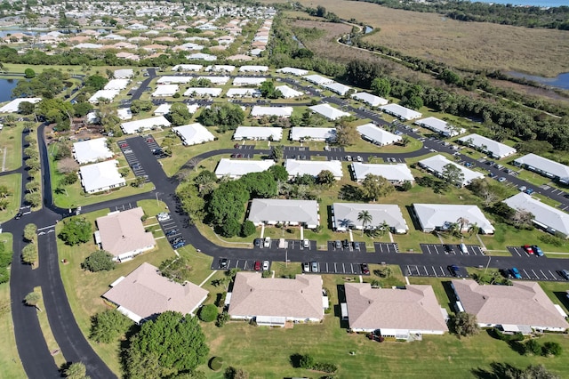 drone / aerial view with a residential view and a water view