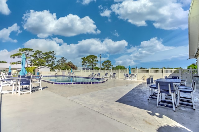 pool featuring a patio and fence