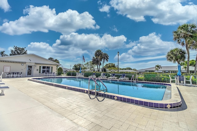 community pool featuring a patio area and fence