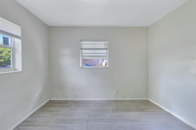 unfurnished room with baseboards