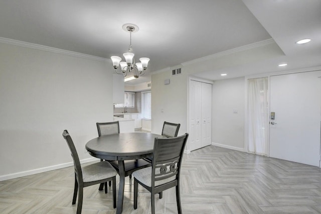 dining area featuring crown molding, visible vents, baseboards, and a chandelier