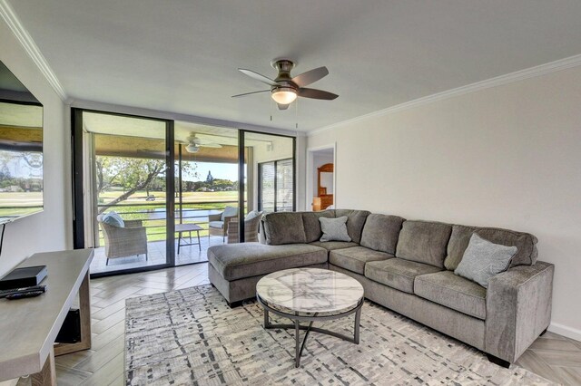 living area featuring a wall of windows, a ceiling fan, a sunroom, and ornamental molding