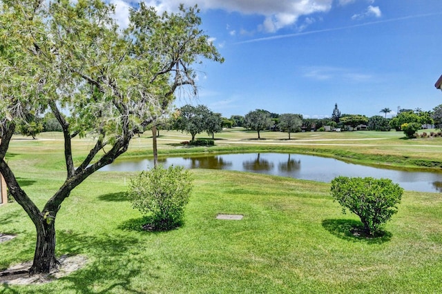 exterior space with a water view and a lawn