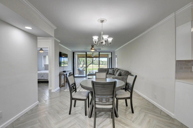 dining space with ceiling fan with notable chandelier, baseboards, and ornamental molding