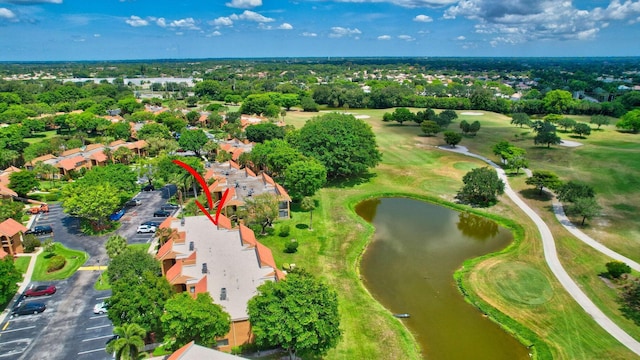 birds eye view of property featuring golf course view and a water view