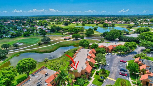 birds eye view of property featuring view of golf course and a water view