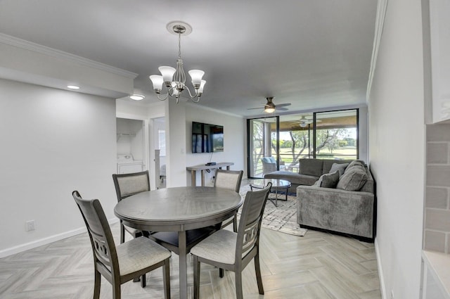 dining space with washer / clothes dryer, ceiling fan with notable chandelier, baseboards, and ornamental molding