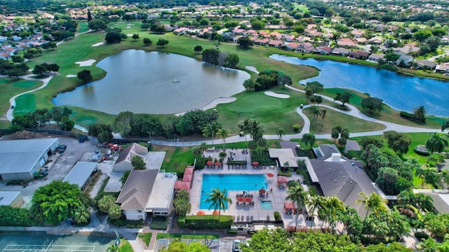 aerial view with view of golf course, a water view, and a residential view