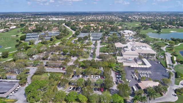 drone / aerial view featuring a residential view, a water view, and view of golf course