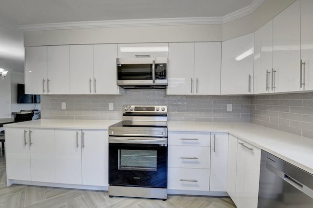 kitchen featuring stainless steel appliances, white cabinetry, crown molding, and light countertops