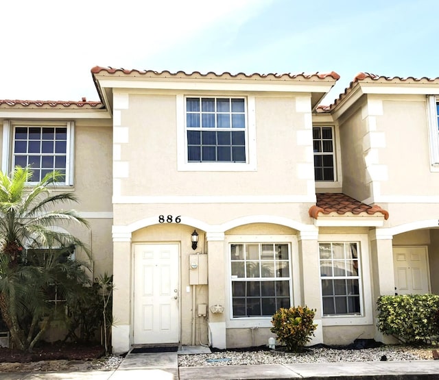 view of front of home with stucco siding and a tiled roof