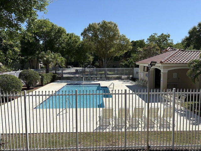 pool featuring a patio and fence