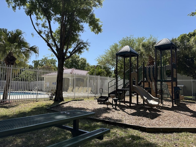 community jungle gym featuring a fenced in pool and fence