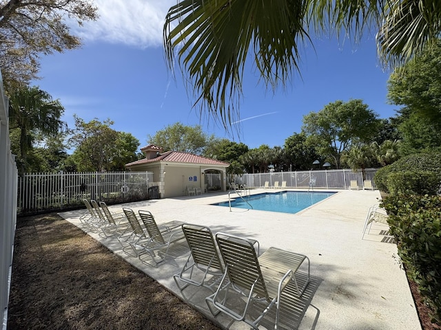 pool featuring a patio and fence