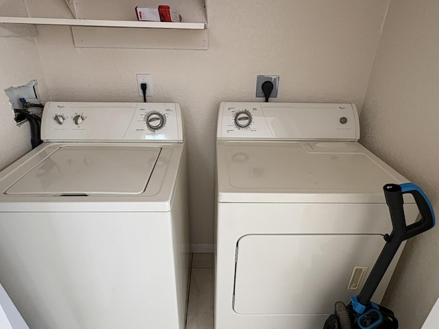 washroom featuring laundry area and separate washer and dryer