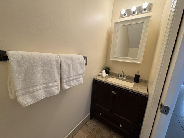 bathroom with tile patterned floors, baseboards, and vanity