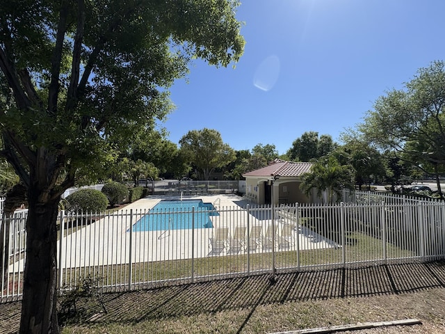 view of pool with a patio area, a fenced in pool, and fence