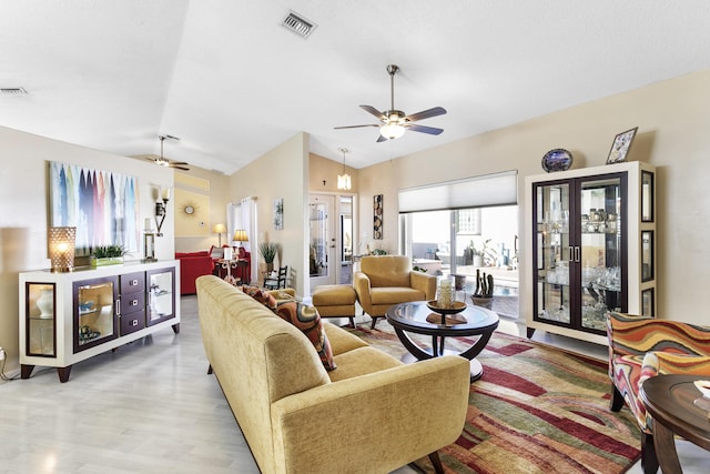 living area featuring vaulted ceiling, light wood-style flooring, visible vents, and ceiling fan