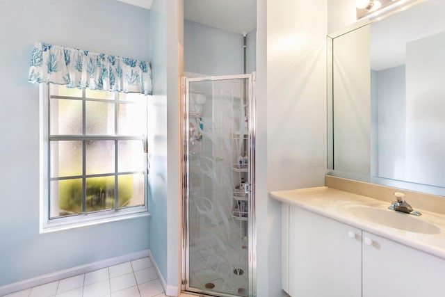 full bathroom with baseboards, vanity, a shower stall, and tile patterned flooring