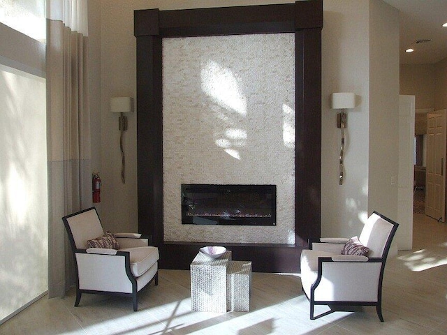 interior space featuring a glass covered fireplace