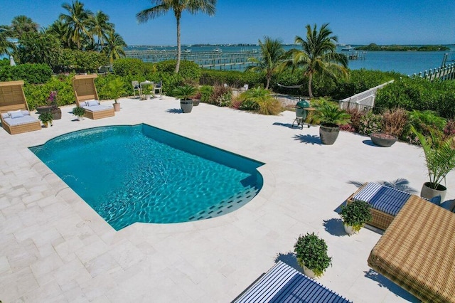 outdoor pool featuring a patio and fence