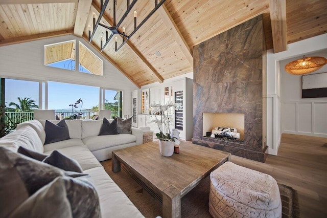 living room featuring wooden ceiling, wood finished floors, and beam ceiling