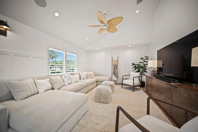 living area with a decorative wall, recessed lighting, high vaulted ceiling, and a ceiling fan