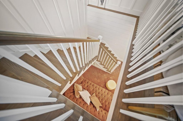 stairs featuring wood walls