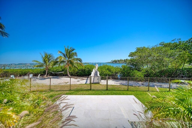 exterior space featuring a water view and fence