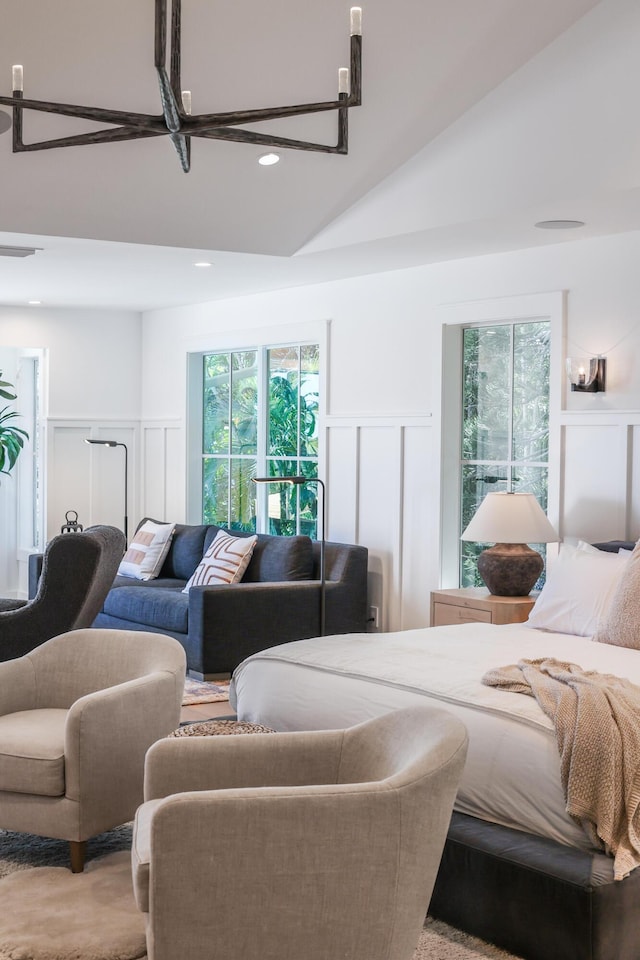 bedroom featuring a decorative wall, recessed lighting, and a wainscoted wall