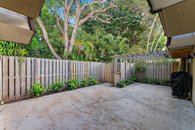 view of patio featuring a grill, a pergola, and a fenced backyard