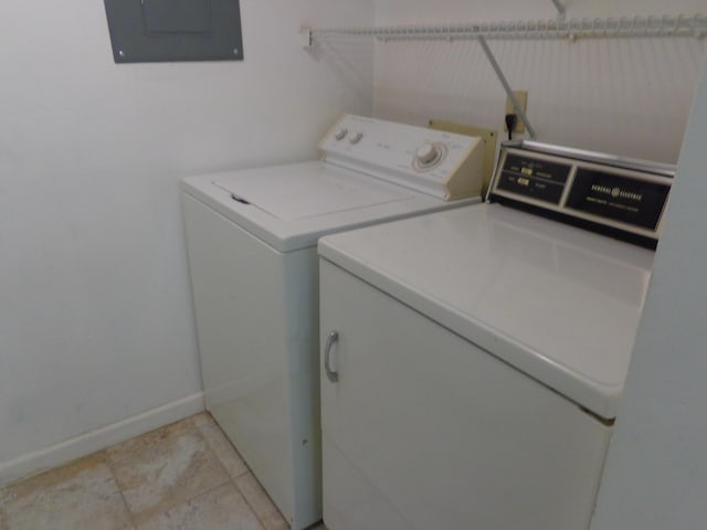 washroom with washing machine and clothes dryer, baseboards, electric panel, laundry area, and light tile patterned flooring